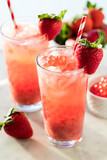 Glasses of refreshing strawberry lemonade with bubble popping pearls.