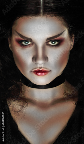 Closeup beauty portrait of young brunette woman witch with bright makeup and confident look, Close-up enchantment: A girl with bewitching sorceress makeup, casting a captivating portrait spell