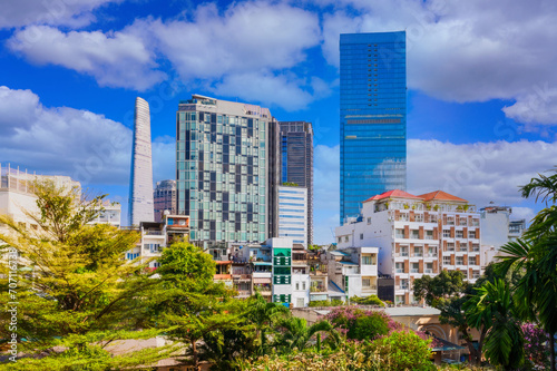 Vibrant Cityscape with Lush Greenery  Modern and Traditional Buildings Under Blue Sky with Clouds