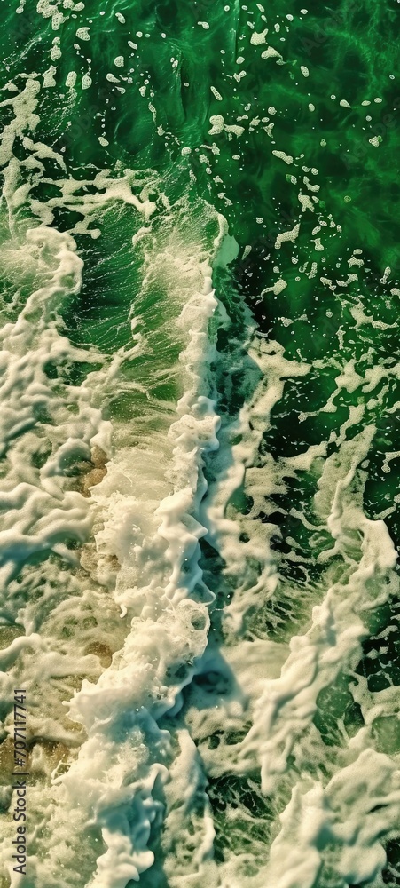 Fototapeta premium The relentless rhythm of the ocean's waves crashing upon the shore, a timeless dance between nature's water resources and the vast outdoor expanse
