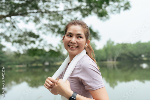 Portrait of a woman in fitness wear running in a park. Close up of a smiling man running while listening to music using earphone