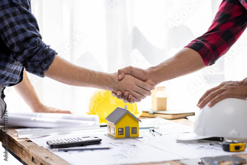Handshake Real estate brokerage agent Deliver a sample of a model house to the customer, mortgage loan agreement startup plan new project house contract home insurance mortgage loan concept 