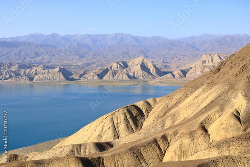 Beautiful landscape with Toktogul lake under colourful barren mountain range  Tien Shan range  Kyrgyzstan  Central Asia