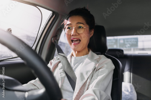Front view of asian Thai woman shocked face and screaming of car crashing, hitting accident on road while driving go to work, traveling. © Suthida