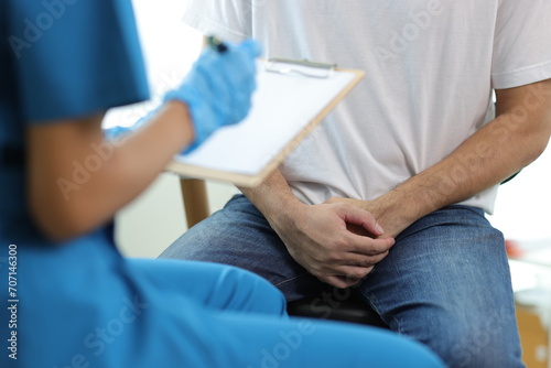 Doctor is diagnosing male erectile dysfunction and giving treatment recommendations, male health problems. photo