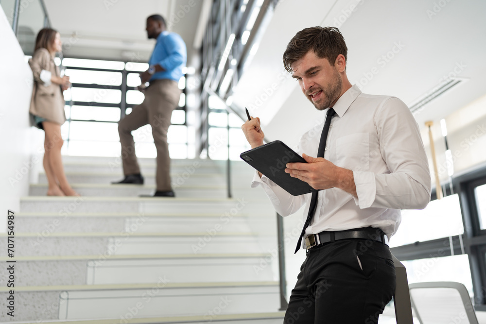 Success Caucasian businessman working with tablet computer at office Success Caucasian businessman working with tablet computer at office