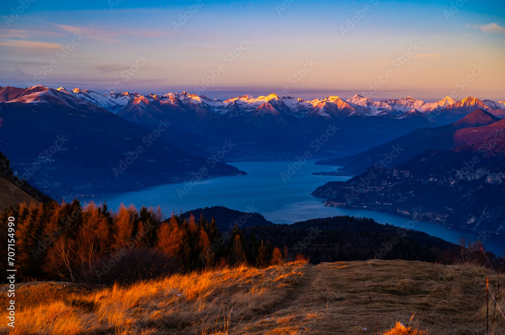 Panorama of Lake Como, photographed in winter, at sunset, from Monte San Primo, with the surrounding villages and mountains.