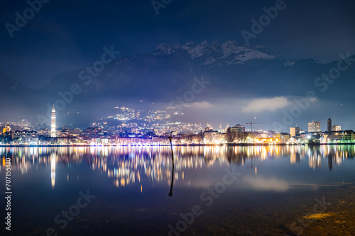 The city of Lecco, with its lakeside promenade and its buildings, photographed in the evening in winter. © leledaniele
