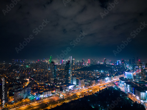 Istanbul's glass and concrete skyscrapers, home to offices, hotels, and residential complexes at night. Aerial drone view