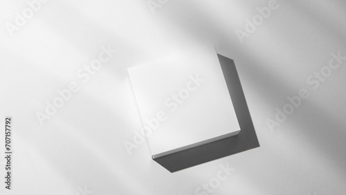 Modern empty podium for product. Minimal white box with shadows on a light background.