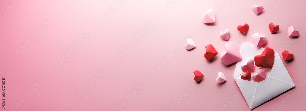 Letter envelop with origami hearts on pink background