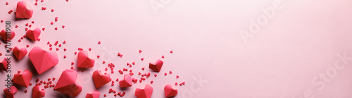 Paper origami hearts on pink background