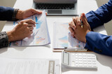 Close up of Asian male company executives working together reviewing business in the office