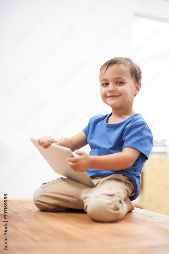 Boy, tablet and portrait with games, kid and internet with network, connection and home. Child development, apartment and technology with online educational activity, face or digital app for learning Boy, tablet and portrait with games, kid and internet with network, connection and home. Child development, apartment and technology with online educational activity, face or digital app for learning