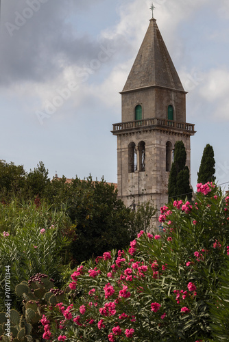 Ancient Cathedral Bell Tower of Osor on Island Cres Croatia Surrounded by Mediterranean Typical Flowers of Oleander