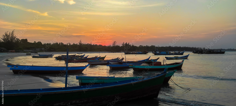 The view of beautiful fishing boats on the shore as the sunset