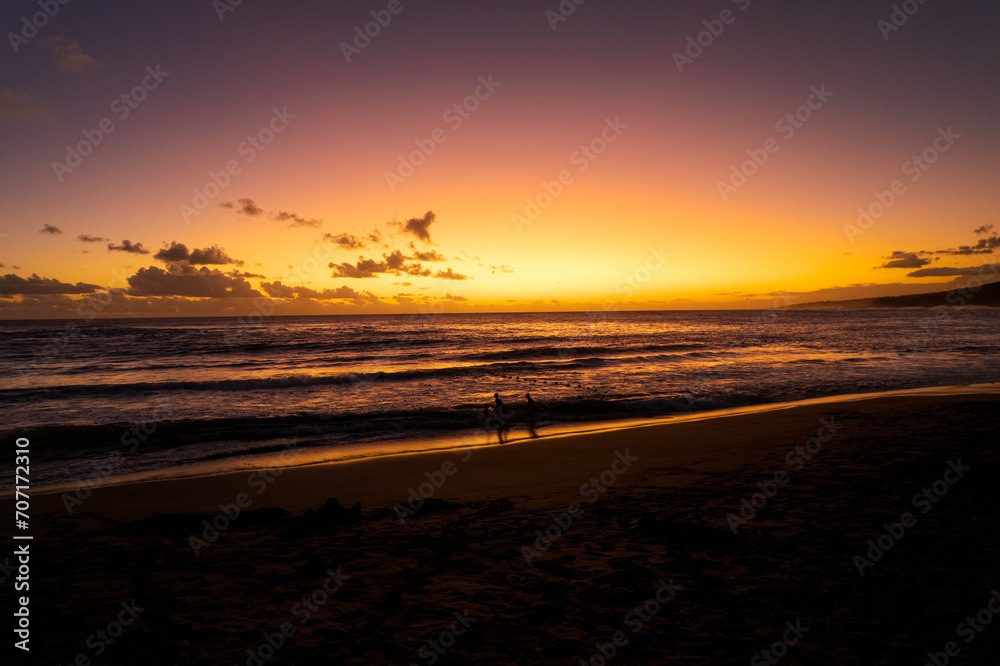 Sunset on the beach of L'Étang-Salé, one of the rare beaches of the island made of volcanic sand, the result of a mixture of basalt and coral, Reunion Island