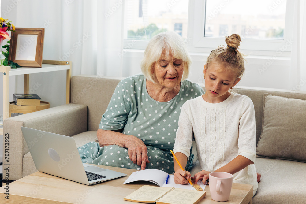 Child hugging grandmother laptop bonding family