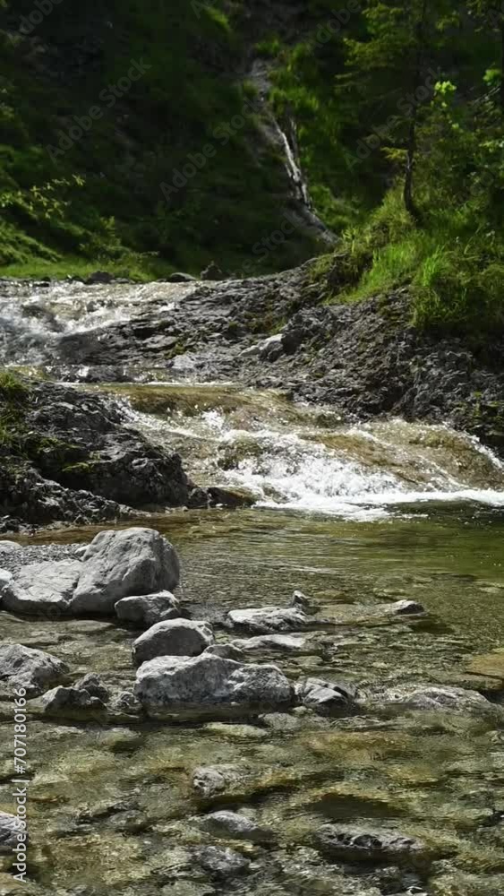 A mountain stream in direct sunlight, backlight, slow motion A mountain stream in direct sunlight, backlight, slow motion