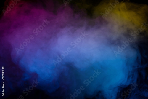 Blue and yellow steam on a black background. © Nikolay