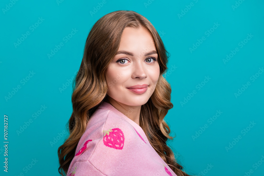 Portrait photo of young adorable woman brown wavy hair wearing pink cardigan strawberry print design isolated on blue color background Portrait photo of young adorable woman brown wavy hair wearing pink cardigan strawberry print design isolated on blue color background