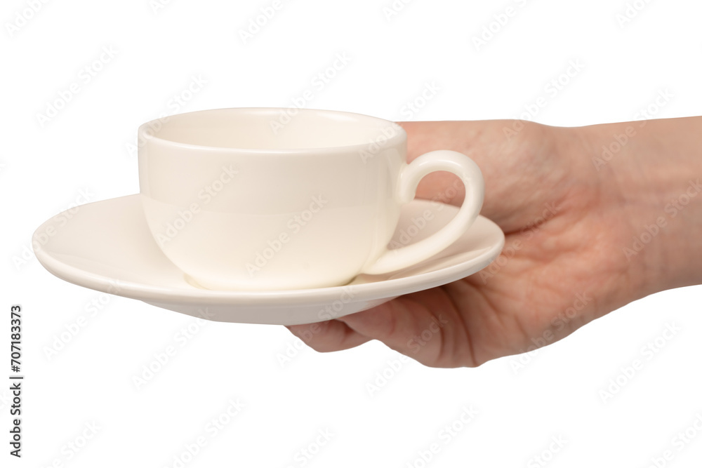 Female hand holding coffee cup and saucer isolated on white background. Female hand holding coffee cup and saucer isolated on white background.