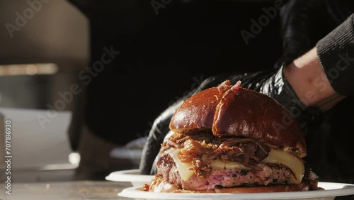 Cooking beef and pork patty with cheese for burger on black grill close-up. Smash fat hamburgers street fast food outdoor. Food concept. photo