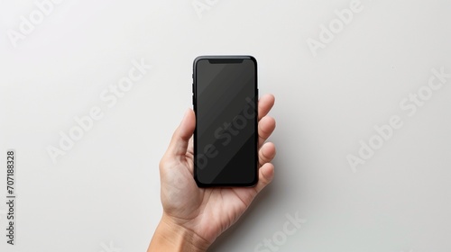  a mobile mock up with black screen over white background in person hand a close up