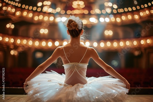 Graceful ballerina posing on a theater stage