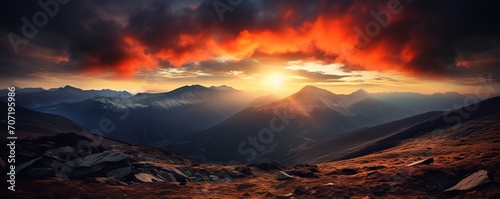 view of the mountains at sunset with a beautiful orange sky