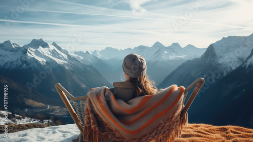 Woman traveler's drinking warm tea in the rustic outdoor cafe and enjoys the scenery in the mountains, snow on hills, generative ai © OP38Studio