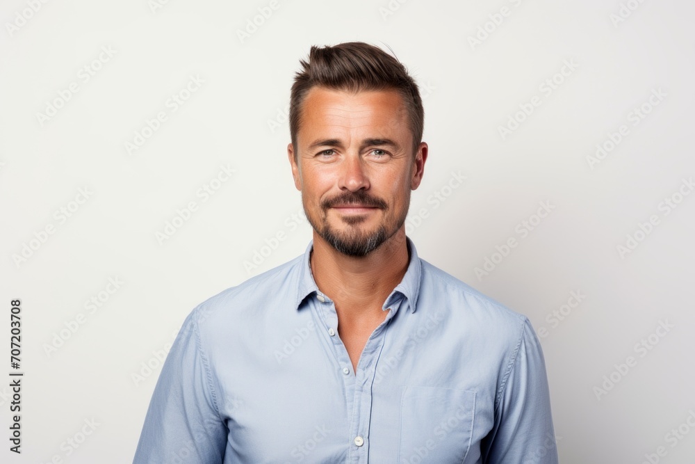 Portrait of a handsome young man in blue shirt on white background Portrait of a handsome young man in blue shirt on white background