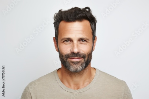 Portrait of a handsome man with beard and mustache on grey background