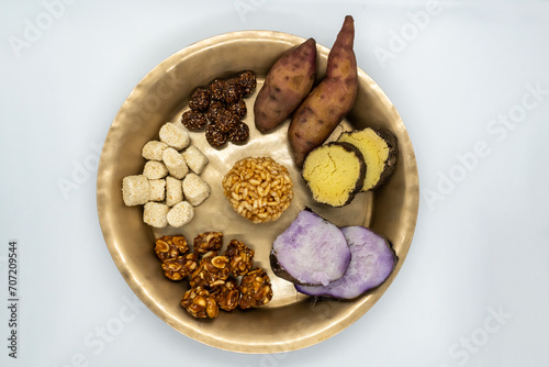 Maghe Sankranti Makar Festival Celebration Food Plate of Muri Ladoo, Sesame Ladoo, Yam, Sweet Potato, Jaggery, Peanuts Ladoo Ghee in India and Nepal photo