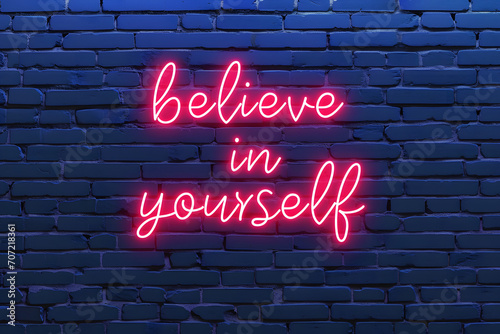 Neon sign with text believe in yourself on brick wall, motivational and inspirational quotes
