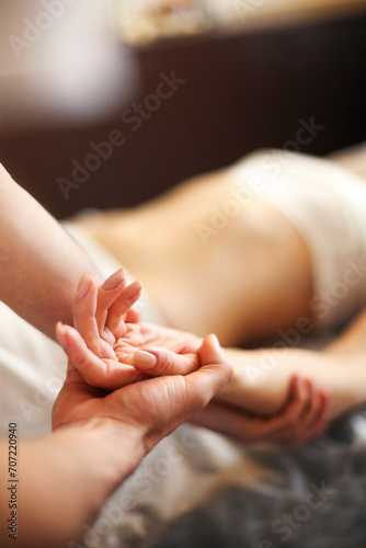 Woman masseur giving massage to client