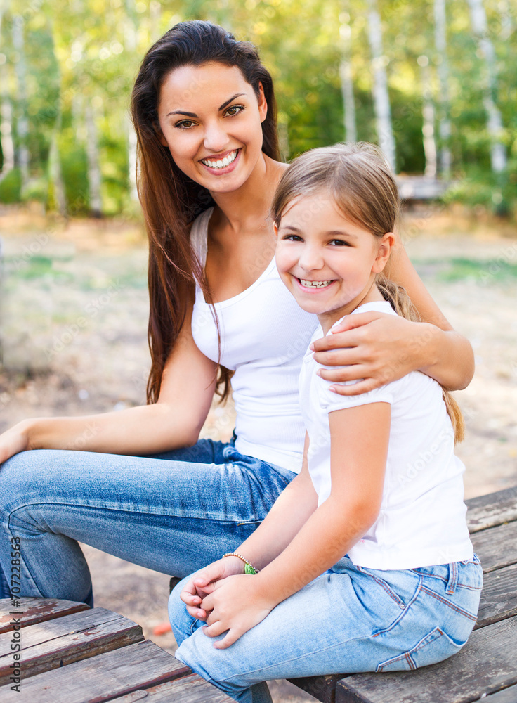 Mother and daughter in the summer park