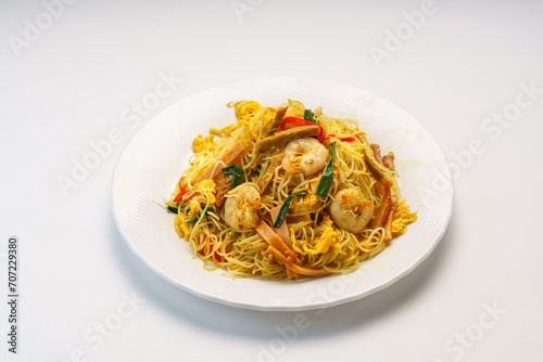 Xingzhou Fried Rice or shrimp fried noodles served in plate isolated on wooden table side view of hong kong fast food