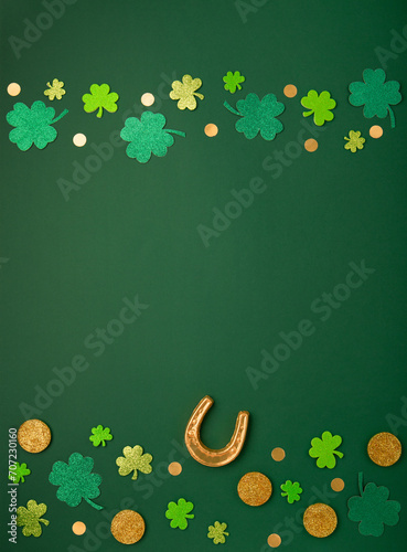 Golden Horseshoe, Gold Coins and Clover Leaves Shamrocks on Green Background for St Patricks Day Concept.