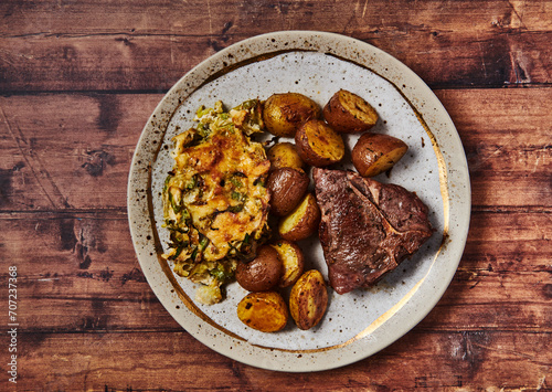 Steak, potatoes and shaved brussels sprouts photo