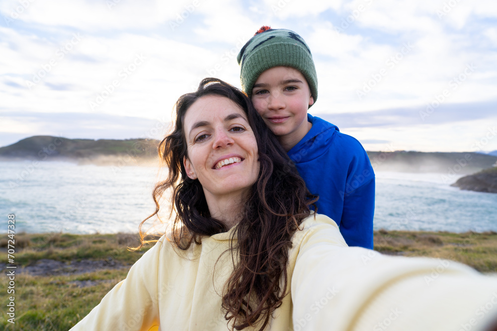 Selfie of mother and son with the sea in the background