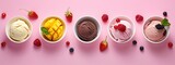 Assorted Flavors of Ice Cream in Bowls with Fresh Fruits on Pink Background