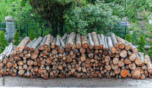 A large stack of firewood has been prepared for the upcoming cold winter. It is standing on the side of the road.