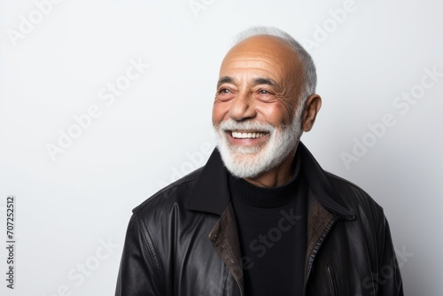 Portrait of a happy senior man in a leather jacket on a white background.
