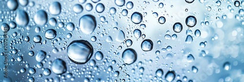 Water drops on glass, blue background.