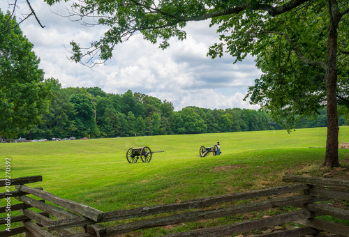 Background of greenfield. One of the cannons of the gun battery at the 24 Gun Trail, Kennesaw Mountain National Battlefield park. The entrance with a huge green field. Historic spots worth to visit. 