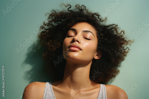 Beautiful young african american woman with curly hair on color background © Synthetica