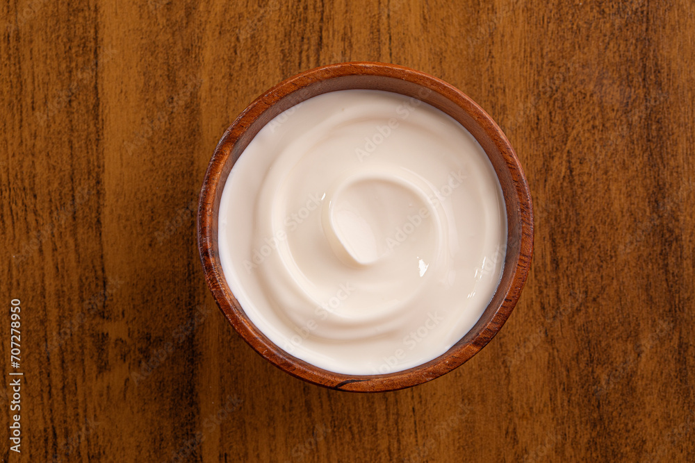Brazilian cream cheese on wooden bowl. Studio shoot isolated on white background.