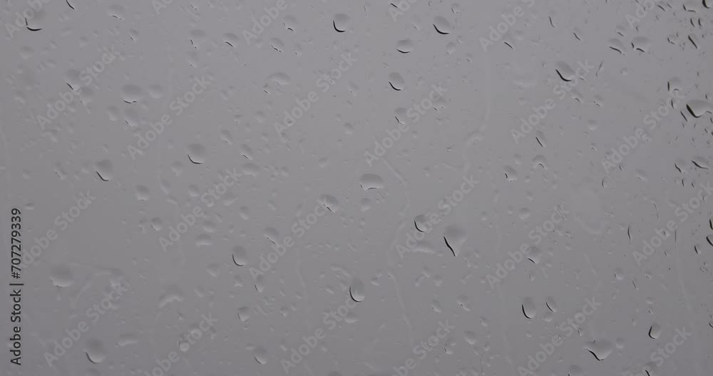 A window with raindrops of different sizes and shapes. A window with raindrops of different sizes and shapes.