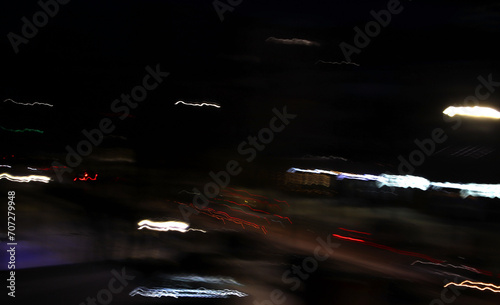 Abstract background. Frizzlight of the night city. Soft bokeh of moving objects.